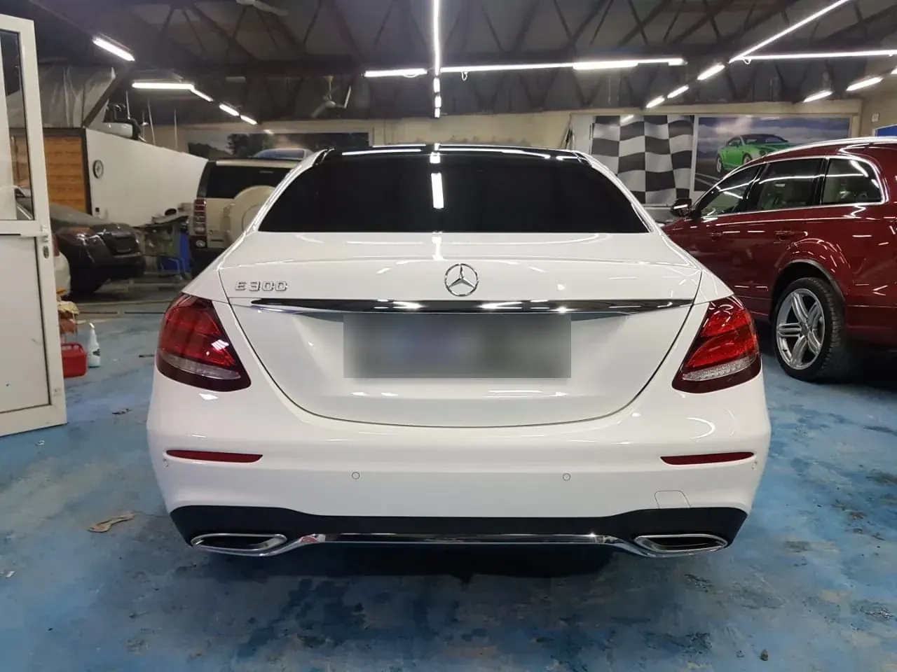 White Mercedes-Benz E300 detailed at Madeena Al Amwaj Auto Workshop