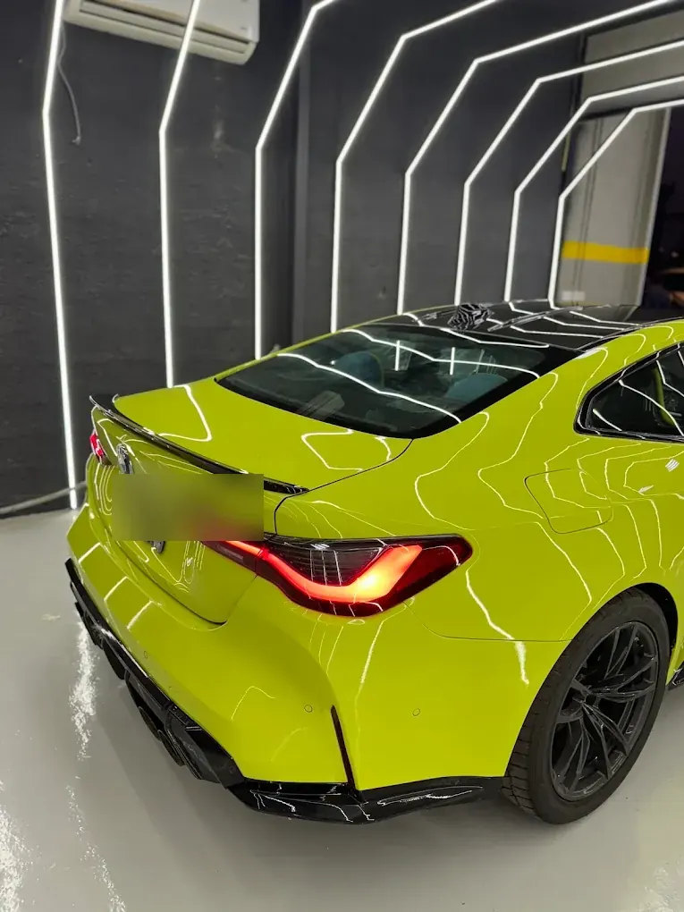 Lime green BMW M4 having paint protection film applied at Madeena Al Amwaj Auto Workshop